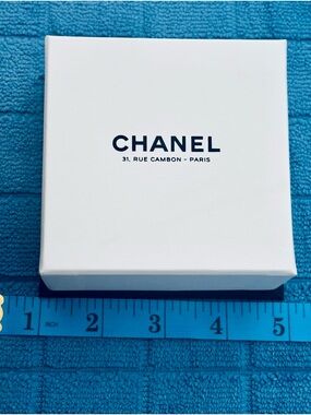 CHANEL White Box with Black Logo on Blue Background